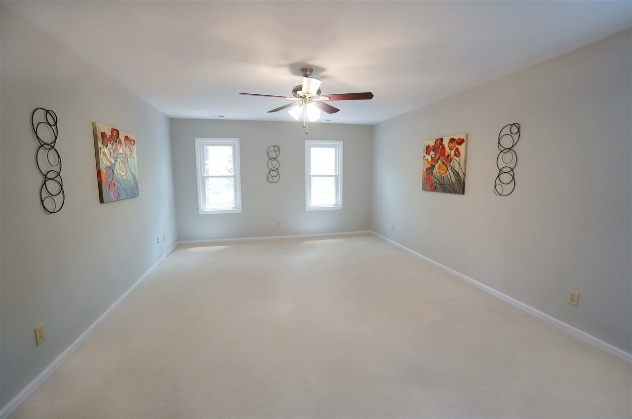 10101 Boxelder Drive Raleigh, NC 27613 - Photo 13 of 25 Master suite is a soothing & relaxing retreat. The large windows provide a soft warm glow that emit a tranquil energy to the space. Master Bedroom