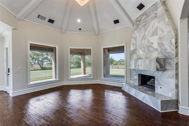 a living room with a fireplace with wooden floor