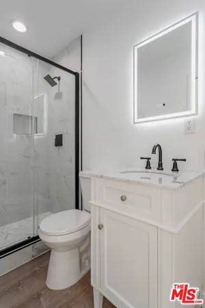 a bathroom with a toilet sink and shower