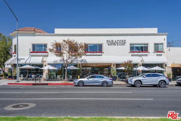 a view of building with cars parked