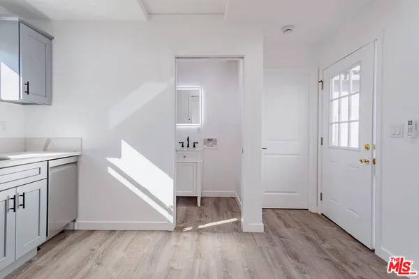 a view of a kitchen with wooden floor and electronic appliances