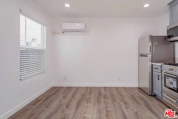 a view of a kitchen with a sink wooden floor and a window