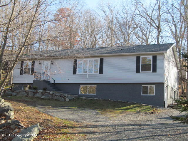 334 Canterbury Road Bushkill, PA 18324 - Photo 1 of 20 a view of a house with a yard covered with snow in the outdoor space