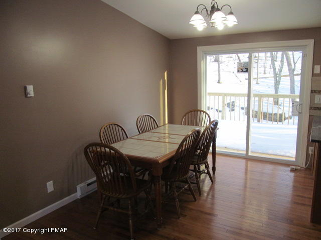 334 Canterbury Road Bushkill, PA 18324 - Photo 11 of 20 a view of a dining room with furniture wooden floor and chandelier