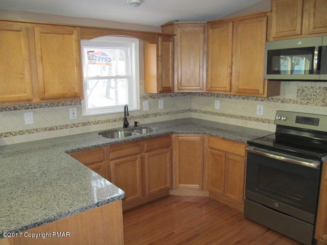 334 Canterbury Road Bushkill, PA 18324 - Photo 10 of 20 a kitchen with granite countertop cabinets stainless steel appliances and a sink