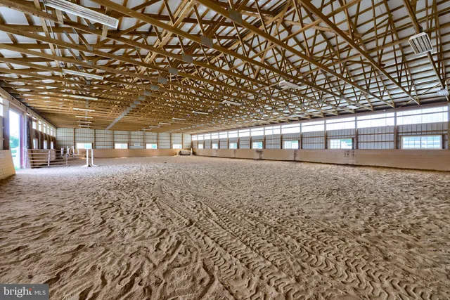 a view of a dining room and livingroom with furniture wooden floor a chandelier