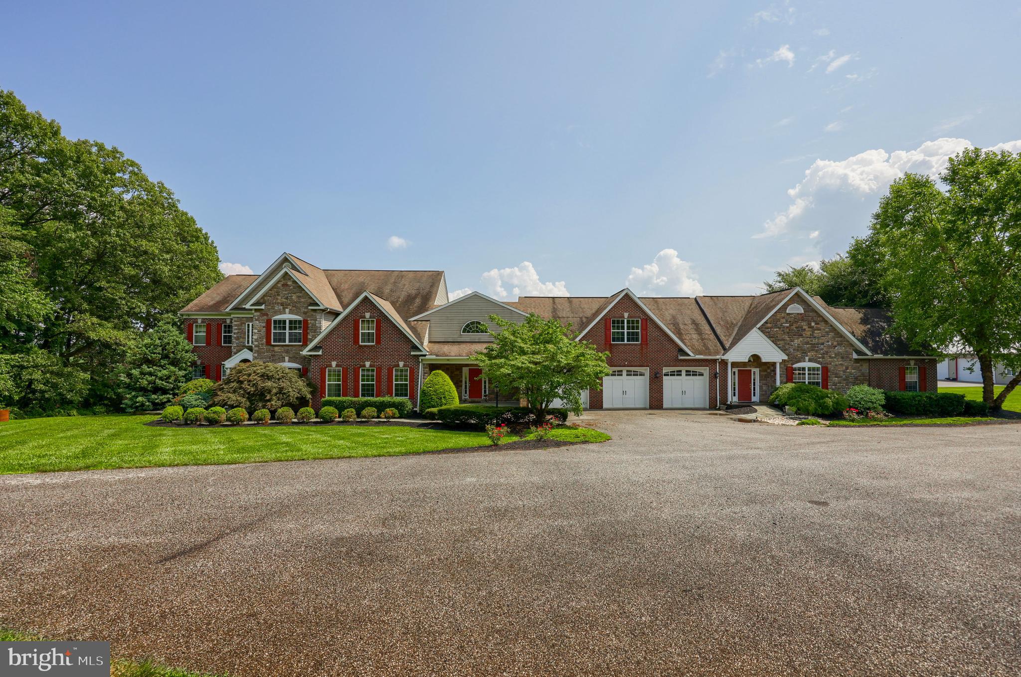 18183 Piedmont Road Stewartstown, PA 17363 - Photo 71 of 81 a front view of a house with a yard and garage
