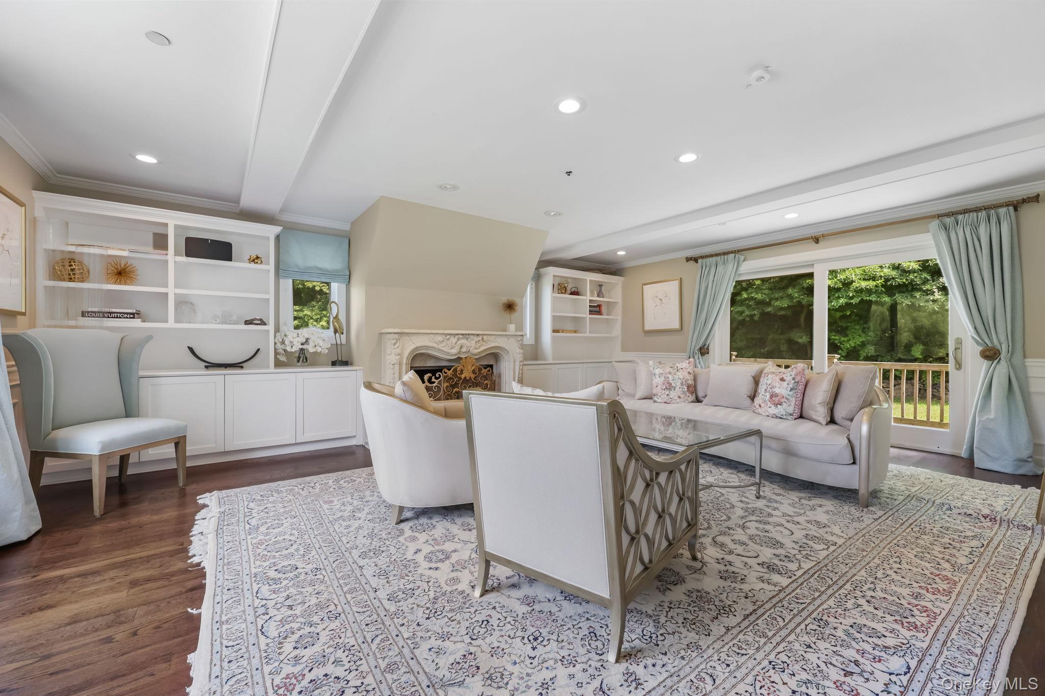 777 Armonk Road Mount Kisco, NY 10549 - Photo 16 of 44 Living room featuring dark wood-style floors, a fireplace, recessed lighting, beamed ceiling, and crown molding