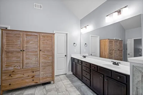 a spacious bathroom with double vanity and mirrors