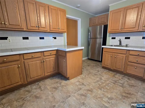 a kitchen with stainless steel appliances granite countertop a refrigerator sink and cabinets