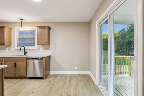 a view of a kitchen with a sink and wooden floor