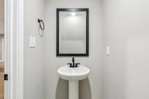 a bathroom with a sink and mirror