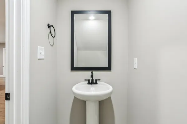 a bathroom with a sink and mirror