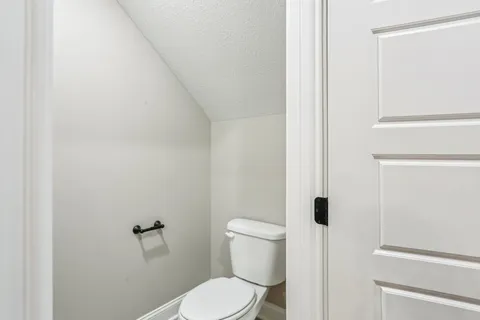 a white toilet sitting next to a bathroom sink