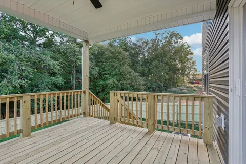 a view of a balcony with wooden floor