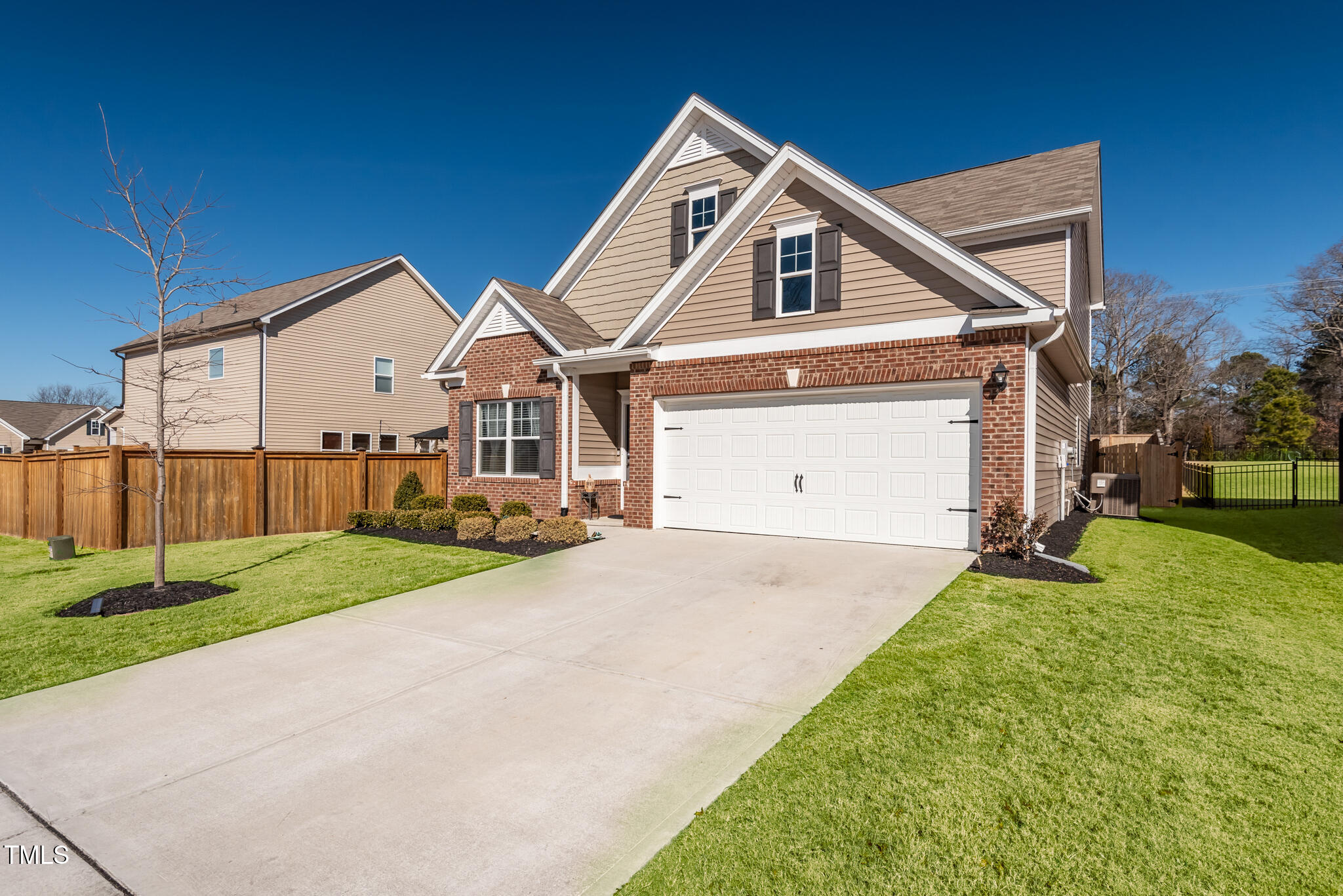 3416 Cross Timber Lane Raleigh, NC 27603 - Photo 2 of 47 a front view of a house with a yard and garage