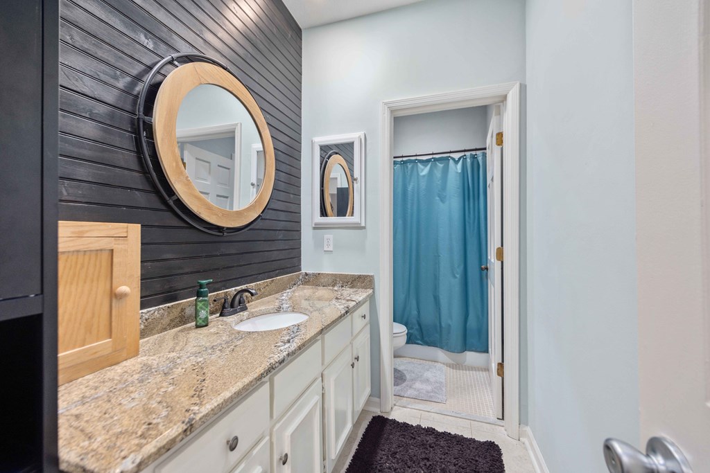 6500 Standing Boy Road, Unit 24 Columbus, GA 31904 - Photo 14 of 23 a bathroom with a granite countertop sink and a mirror