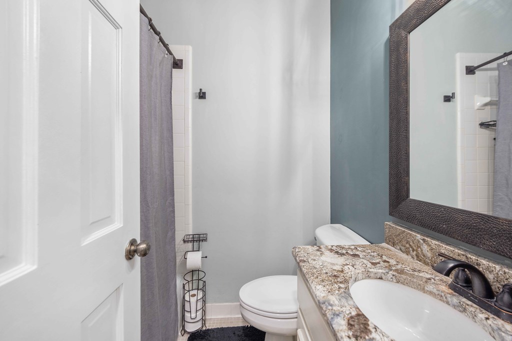 6500 Standing Boy Road, Unit 24 Columbus, GA 31904 - Photo 16 of 23 a bathroom with a granite countertop sink toilet and shower
