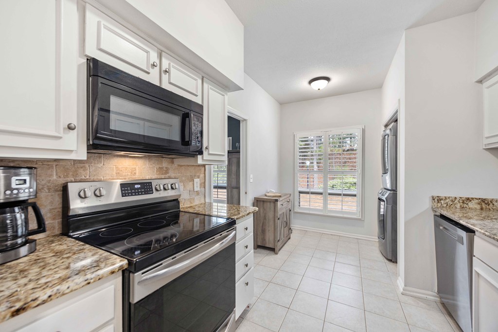 6500 Standing Boy Road, Unit 24 Columbus, GA 31904 - Photo 4 of 23 a kitchen with a stove a microwave and refrigerator