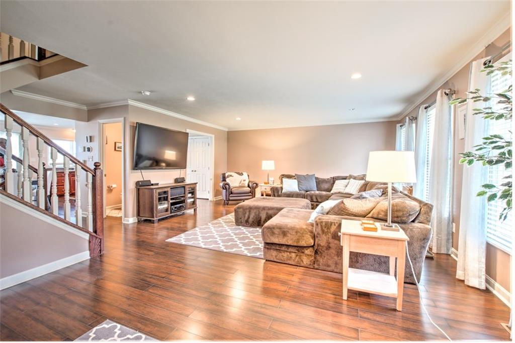 85 Castle View Drive McKees Rocks, PA 15136 - Photo 2 of 16 Enjoy the spacious family room with recessed lighting, crown molding and new wide plank Pergo flooring.
