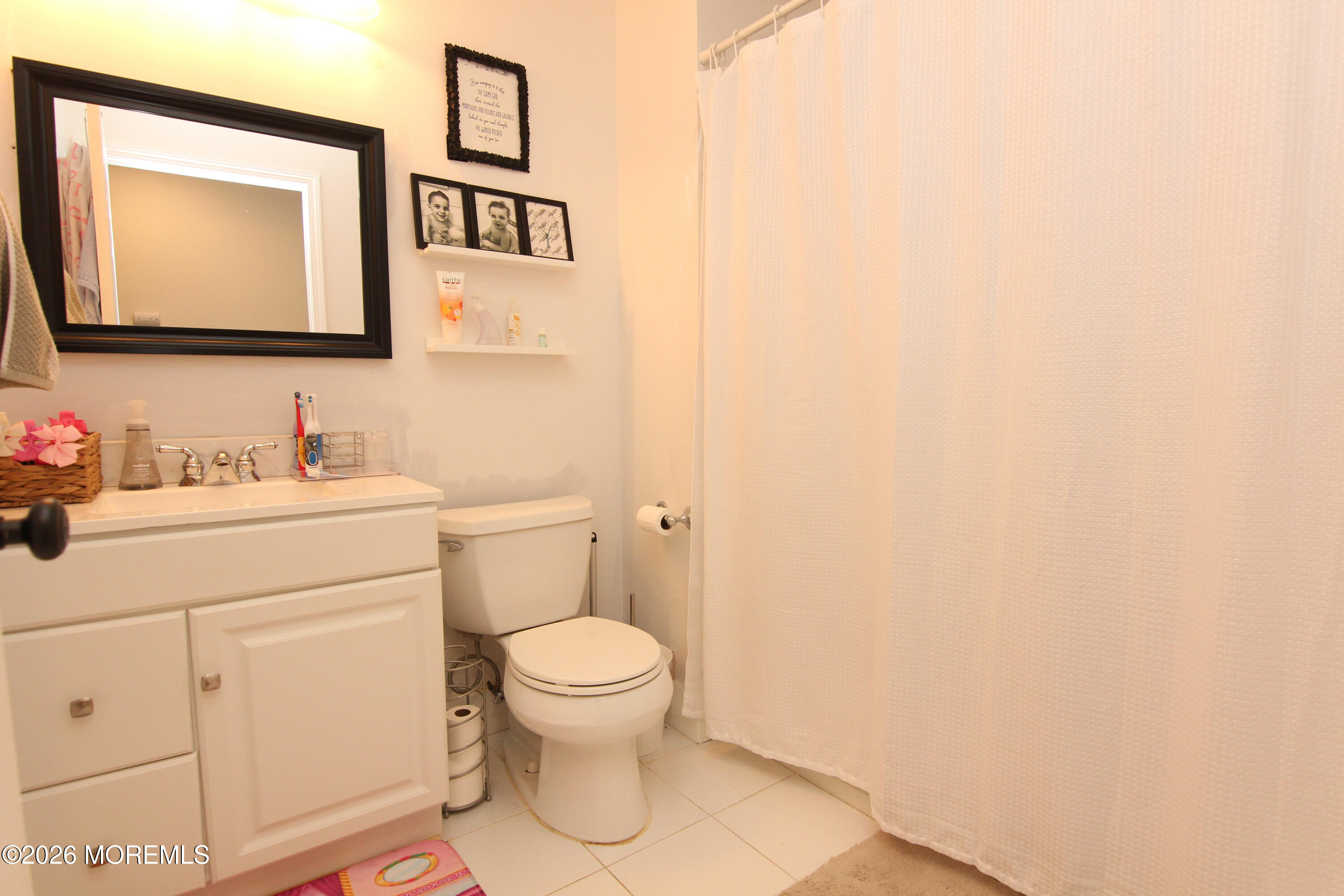 33 Austin Street Tinton Falls, NJ 07712 - Photo 18 of 46 a bathroom with a toilet sink vanity and mirror