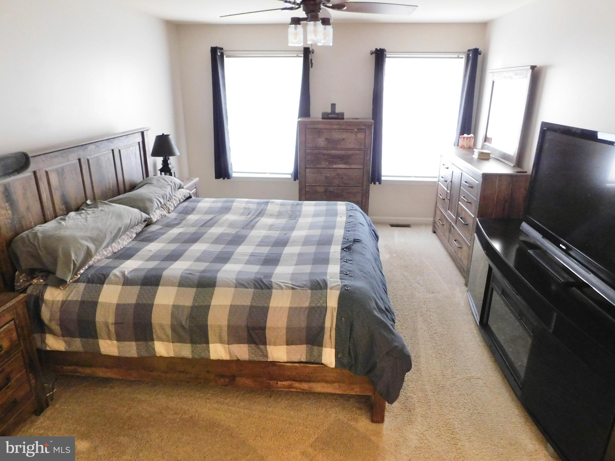 1114 West Springfield Drive Bellefonte, PA 16823 - Photo 20 of 43 a bedroom with a bed and a flat tv screen on dresser