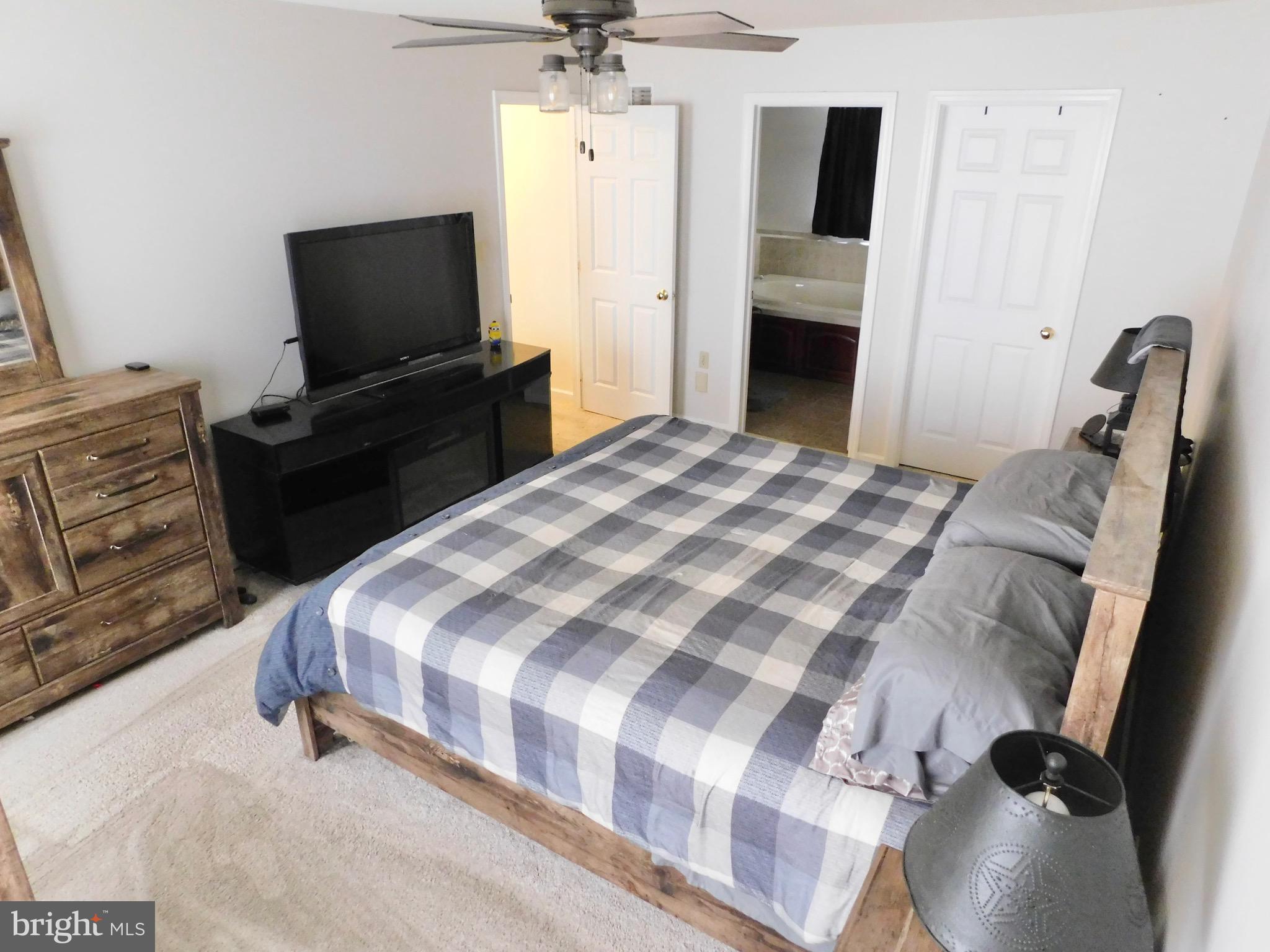 1114 West Springfield Drive Bellefonte, PA 16823 - Photo 21 of 43 a bedroom with a bed and a flat screen tv