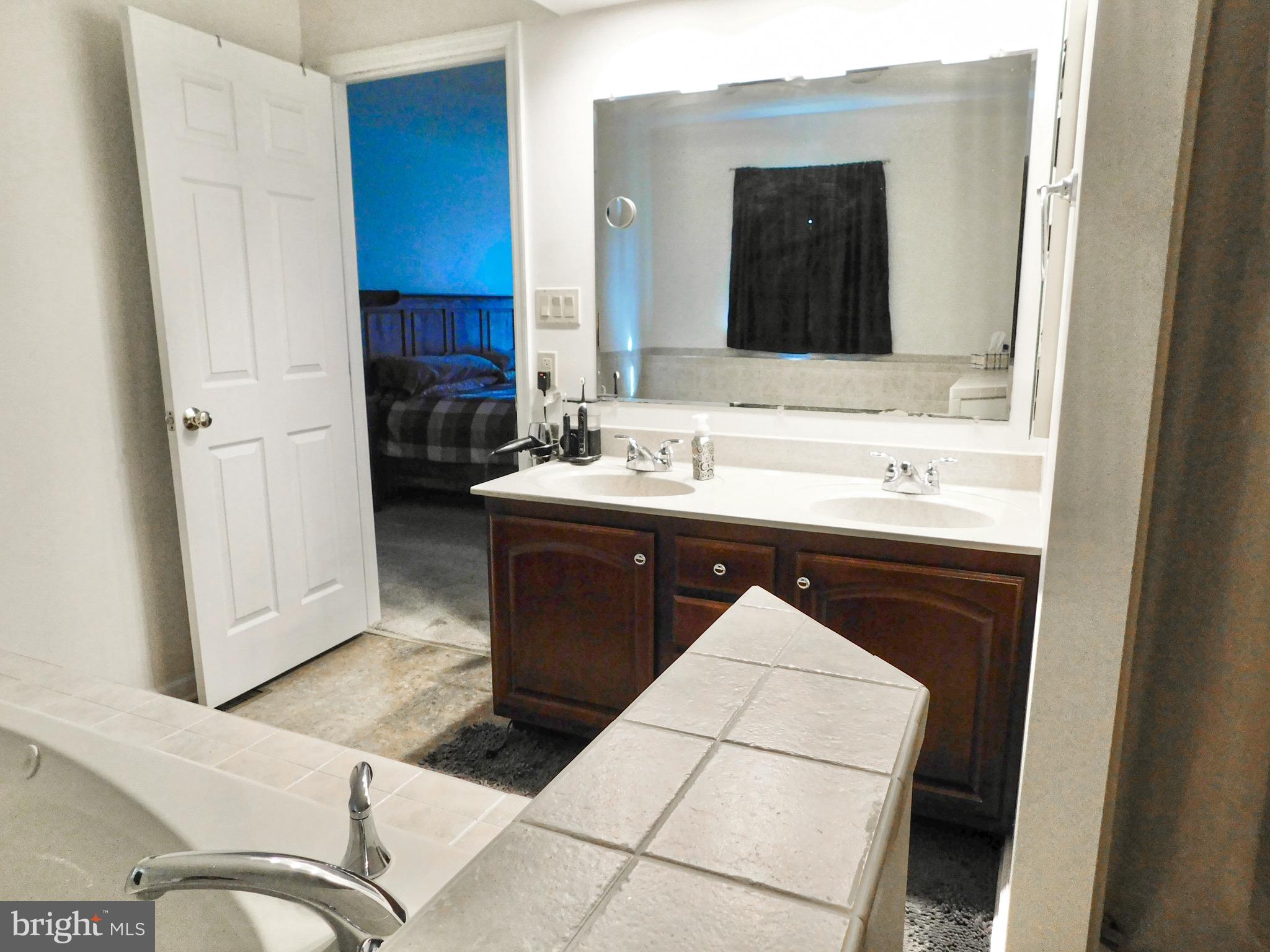 1114 West Springfield Drive Bellefonte, PA 16823 - Photo 22 of 43 a en suite bathroom with a sink and a mirror