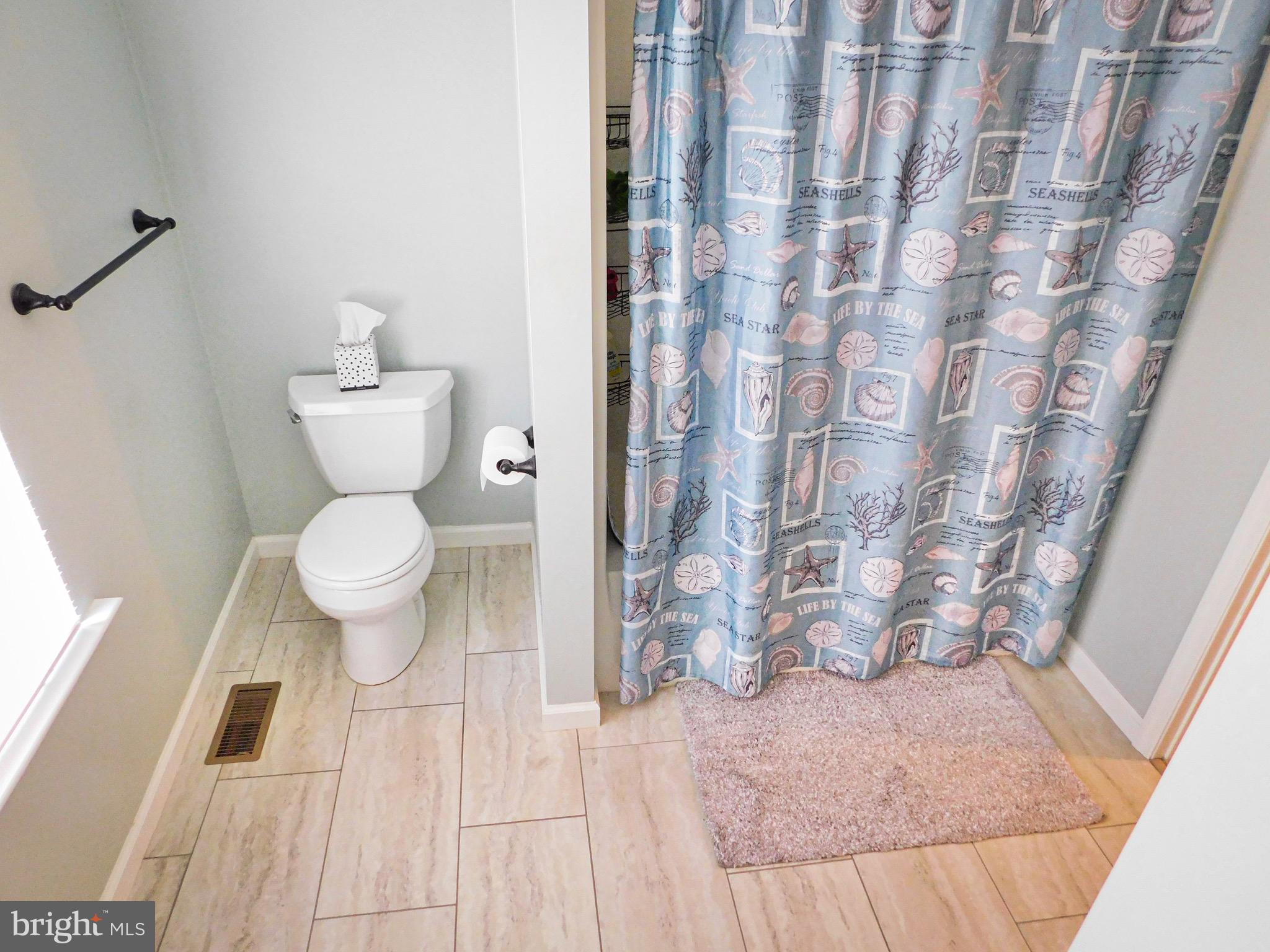 1114 West Springfield Drive Bellefonte, PA 16823 - Photo 29 of 43 a bathroom with a toilet and a shower curtain