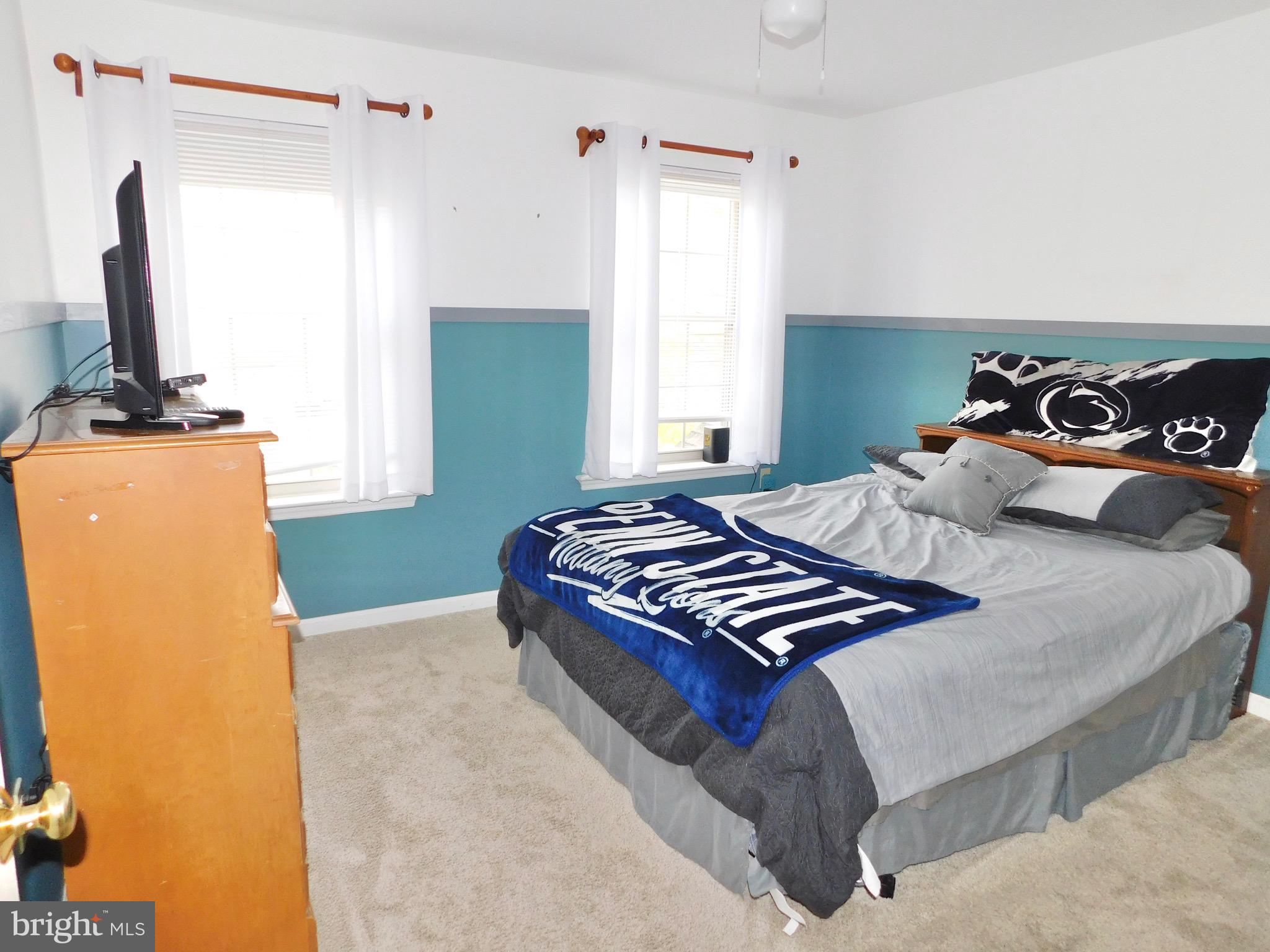 1114 West Springfield Drive Bellefonte, PA 16823 - Photo 31 of 43 a bedroom with a bed and a flat tv screen on the dresser