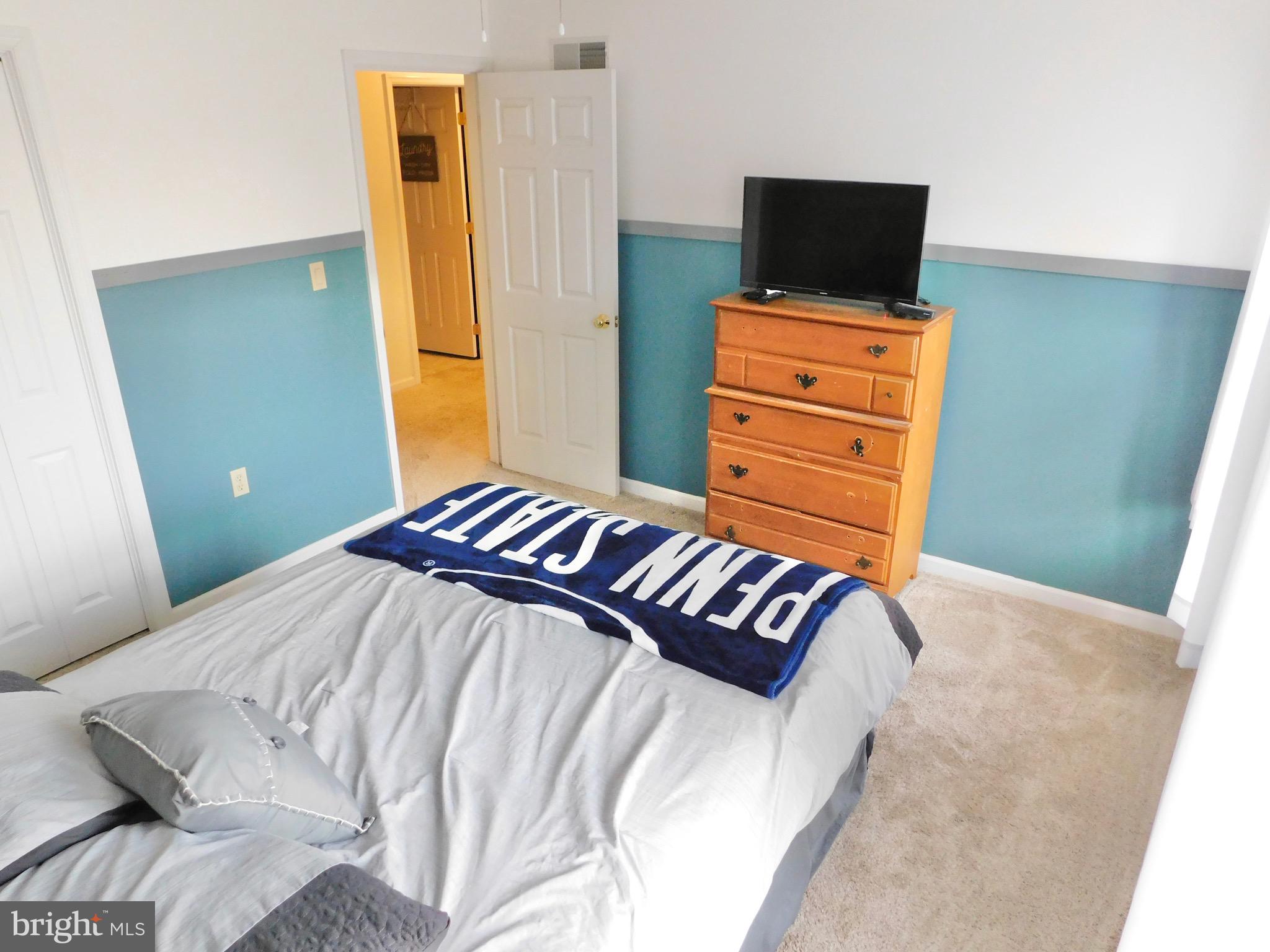 1114 West Springfield Drive Bellefonte, PA 16823 - Photo 33 of 43 a bedroom with a bed and flat screen tv