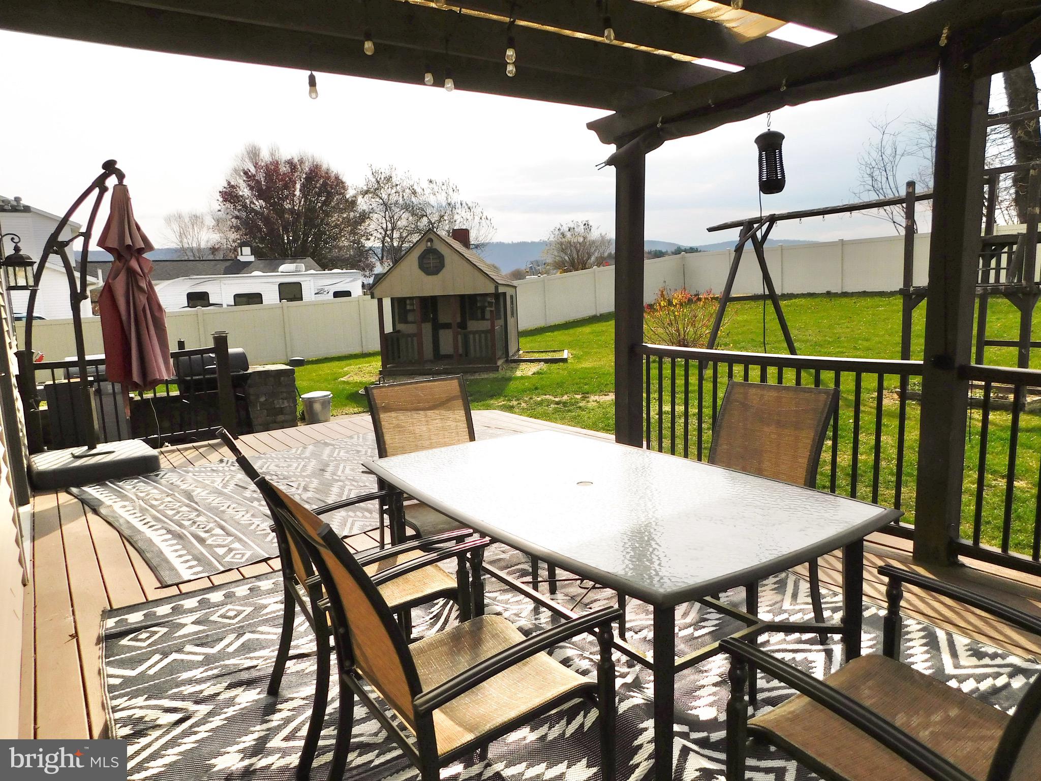 1114 West Springfield Drive Bellefonte, PA 16823 - Photo 38 of 43 a view of a patio with table and chairs with wooden floor and fence