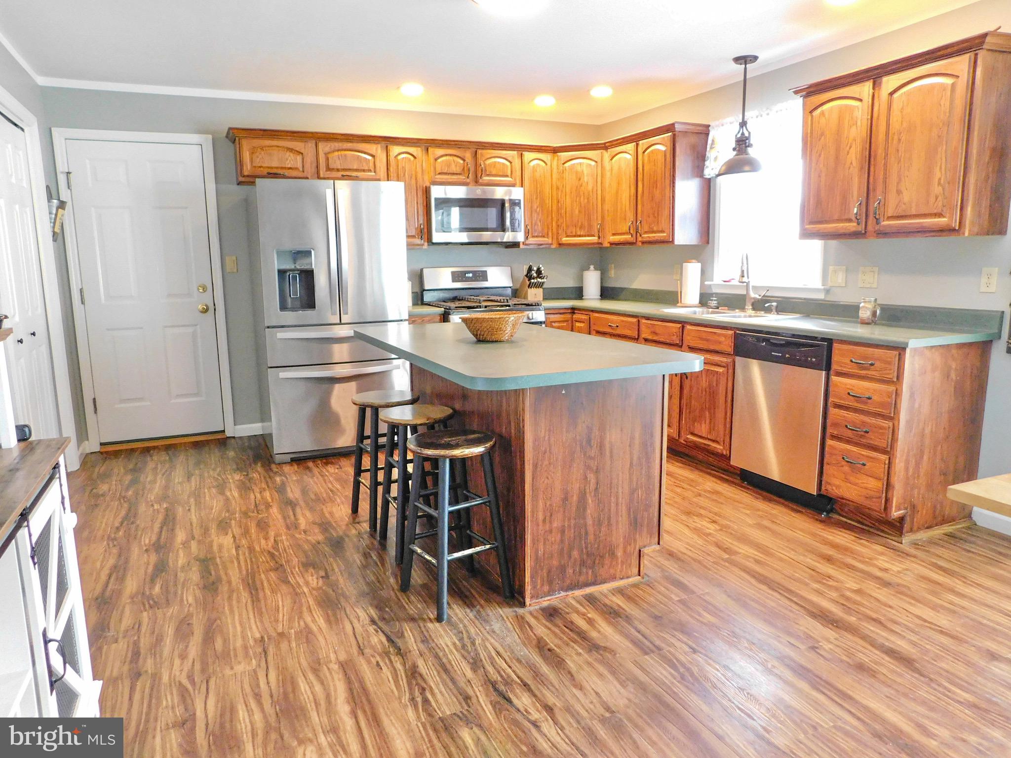 1114 West Springfield Drive Bellefonte, PA 16823 - Photo 5 of 43 a kitchen with stainless steel appliances a sink and wooden floors