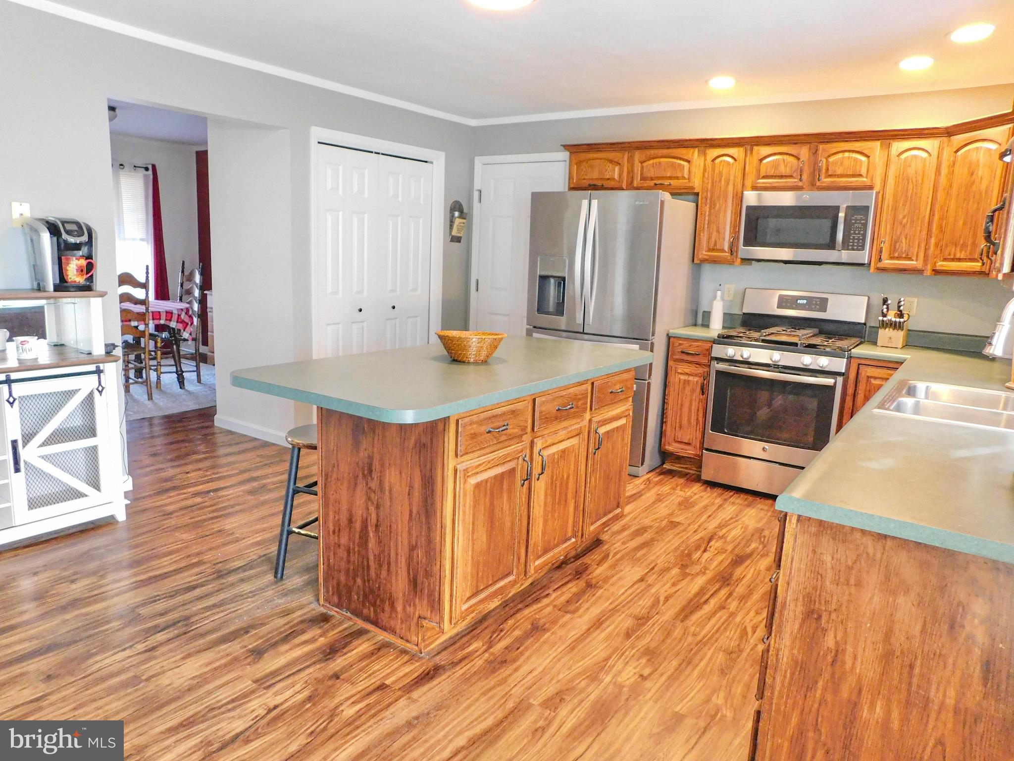1114 West Springfield Drive Bellefonte, PA 16823 - Photo 6 of 43 a kitchen with stainless steel appliances granite countertop a stove a sink dishwasher and a refrigerator with wooden floor