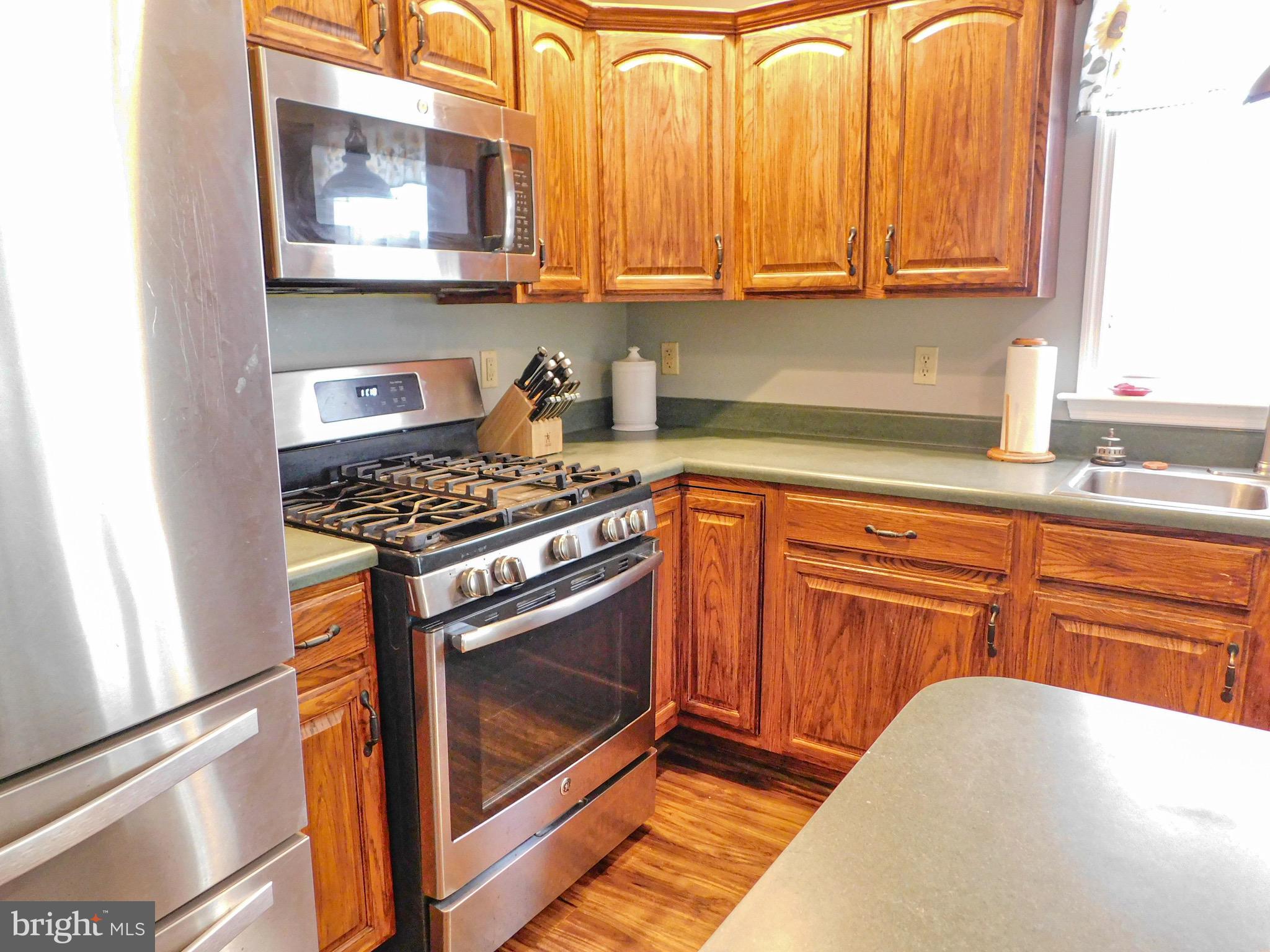 1114 West Springfield Drive Bellefonte, PA 16823 - Photo 7 of 43 a kitchen with wooden cabinets and a stove top oven