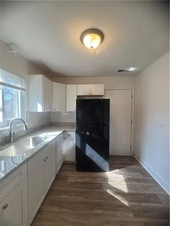 a kitchen with stainless steel appliances granite countertop a sink and a stove top oven