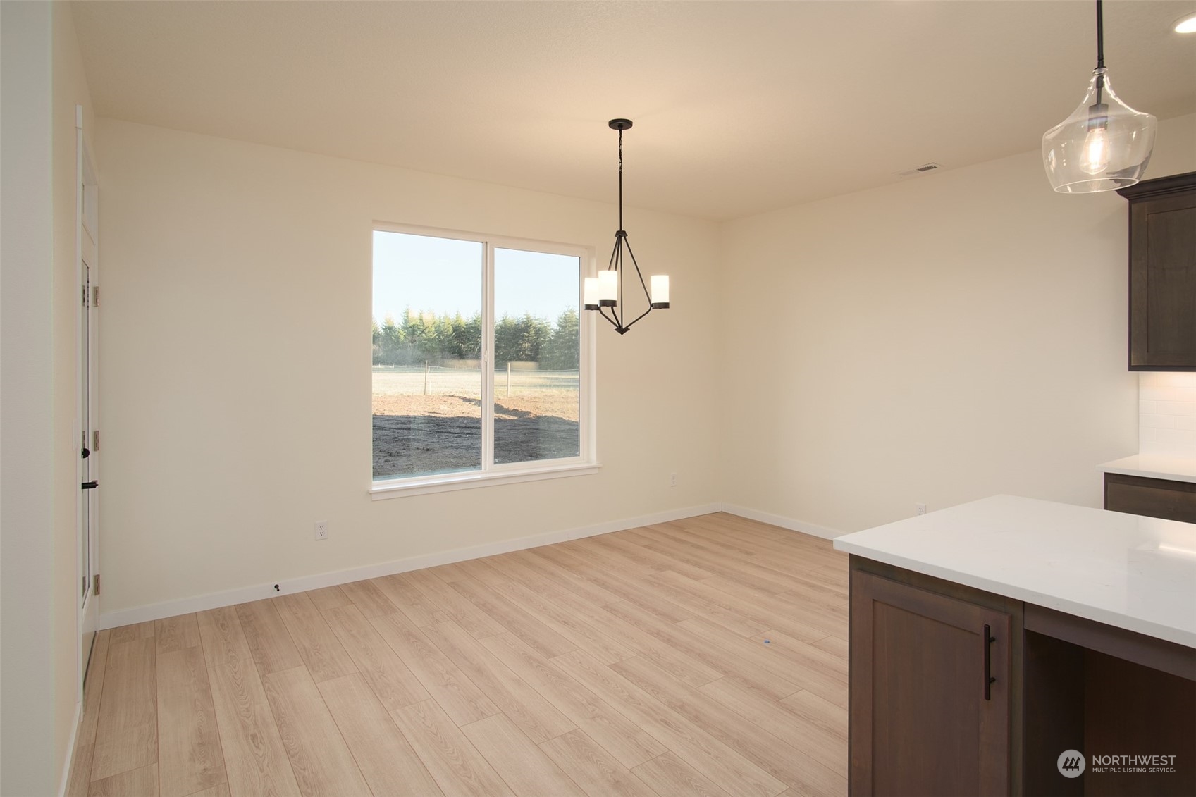 708 Cardinal Avenue Winlock, WA 98596 - Photo 5 of 28 a view of a room with a chandelier fan and wooden floor