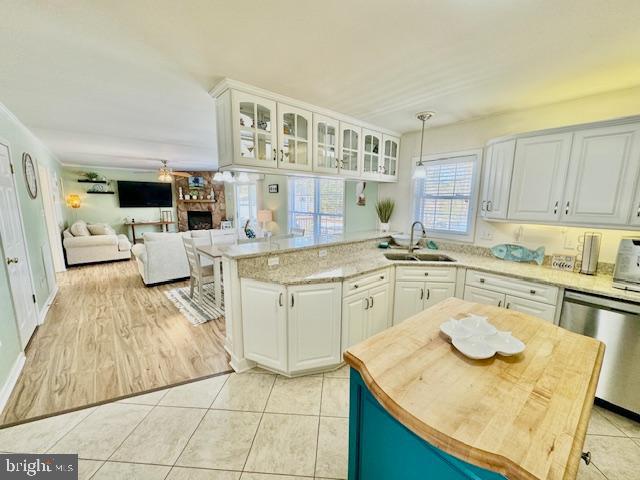 1234 Kelley Neck Road Lancaster, VA 22503 - Photo 13 of 71 a kitchen with a sink dishwasher stove and white cabinets with wooden floor