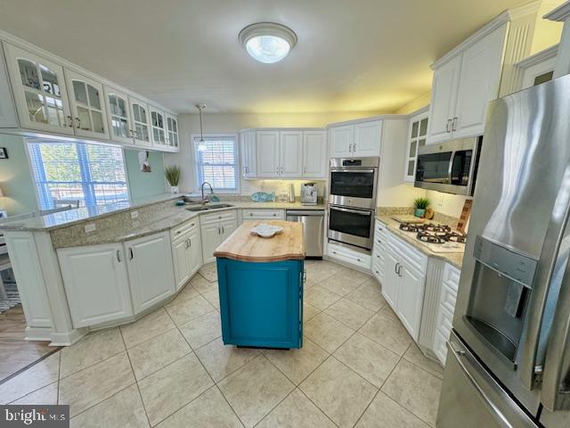 1234 Kelley Neck Road Lancaster, VA 22503 - Photo 23 of 71 a kitchen with stainless steel appliances granite countertop a stove top oven a refrigerator a sink and dishwasher