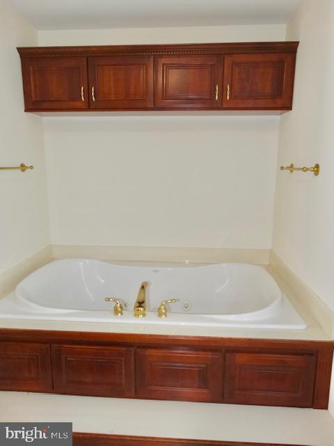 1234 Kelley Neck Road Lancaster, VA 22503 - Photo 35 of 71 a bathroom with a bathtub and vanity