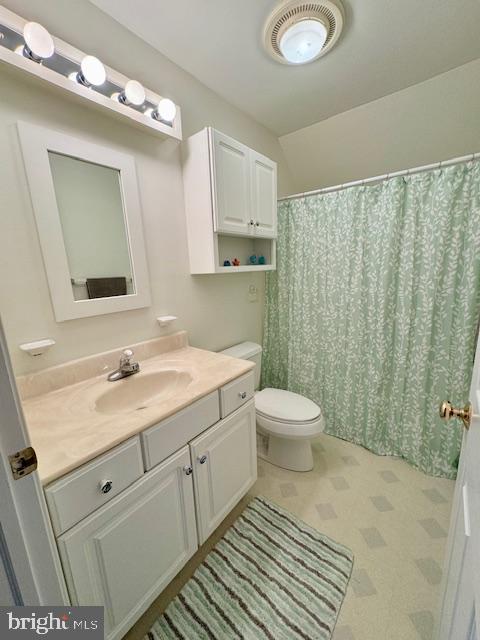1234 Kelley Neck Road Lancaster, VA 22503 - Photo 45 of 71 a bathroom with a granite countertop sink toilet a mirror and shower