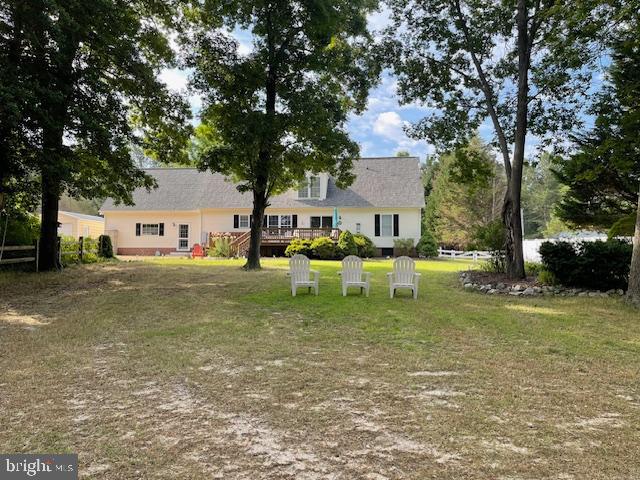 1234 Kelley Neck Road Lancaster, VA 22503 - Photo 62 of 71 a backyard of a house with table and chairs