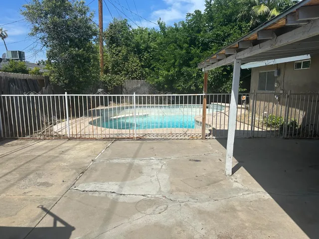 a swimming pool with wooden fence
