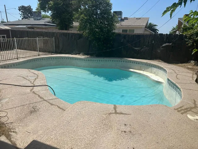 a swimming pool with wooden fence