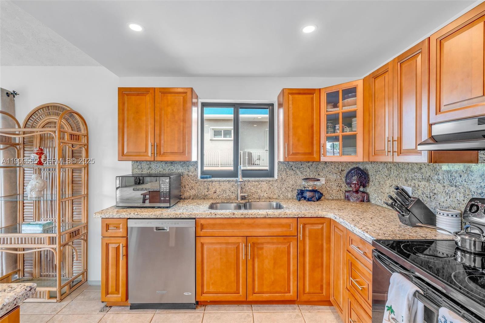 877 Ellen Drive Key Largo, FL 33037 - Photo 11 of 39 a kitchen with stainless steel appliances granite countertop a sink a stove cabinets and a window
