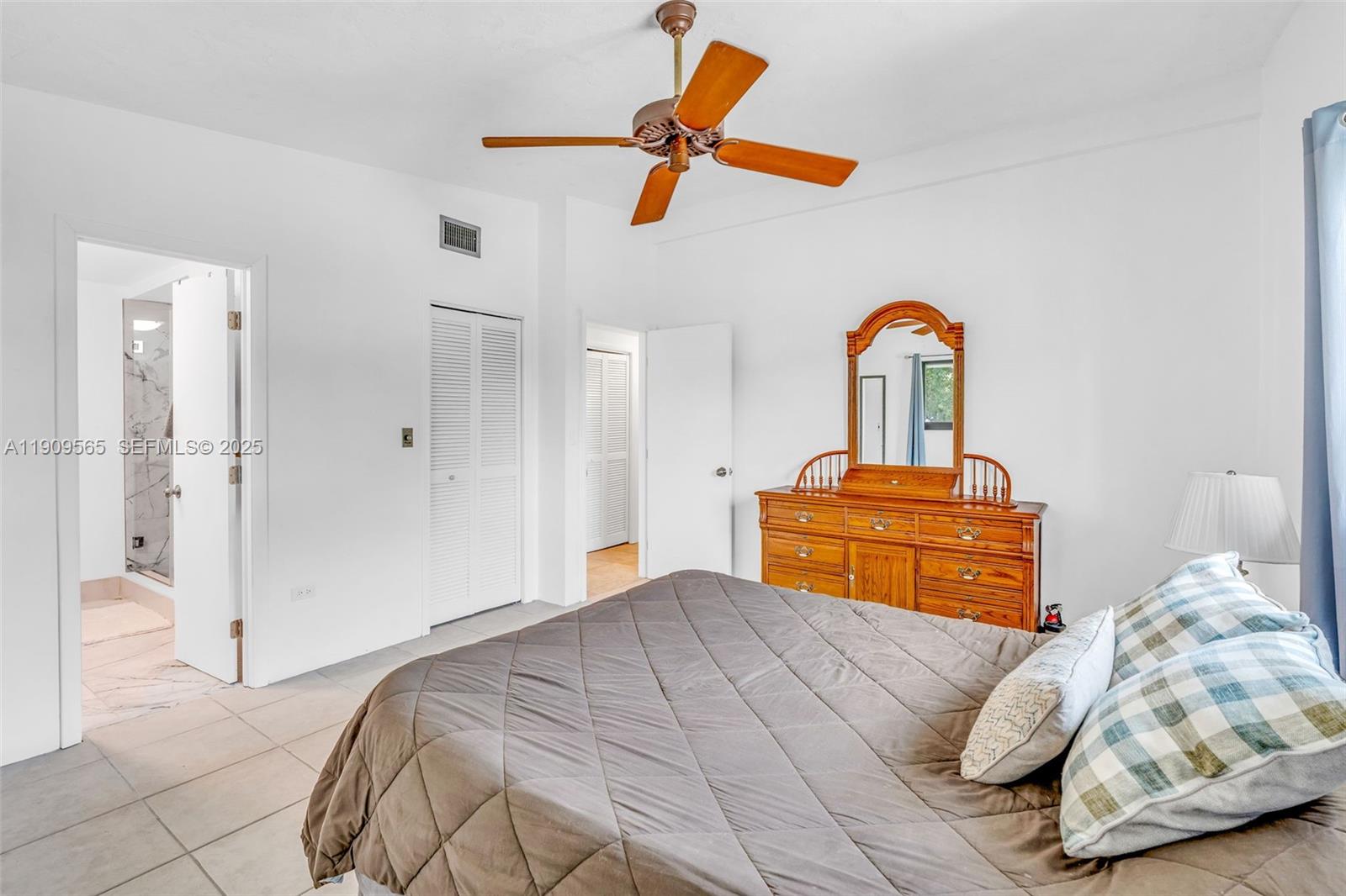 877 Ellen Drive Key Largo, FL 33037 - Photo 14 of 39 a bedroom with a bed and a chandelier