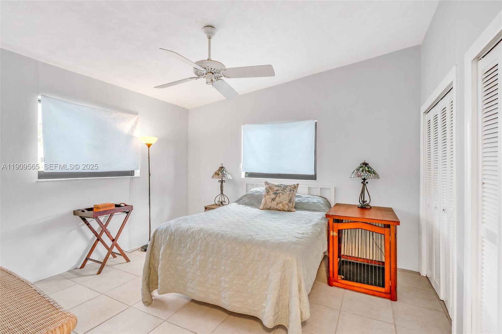 877 Ellen Drive Key Largo, FL 33037 - Photo 17 of 39 a bedroom with a bed and a chandelier