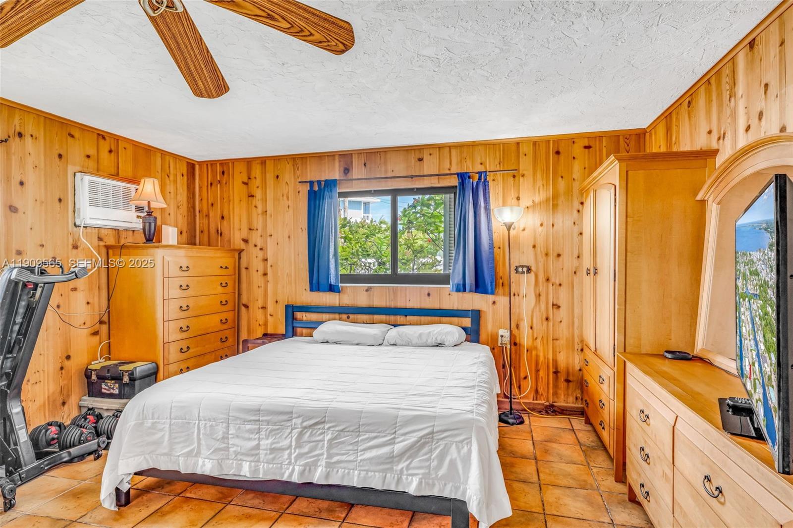 877 Ellen Drive Key Largo, FL 33037 - Photo 20 of 39 a bedroom with a bed and wooden floor