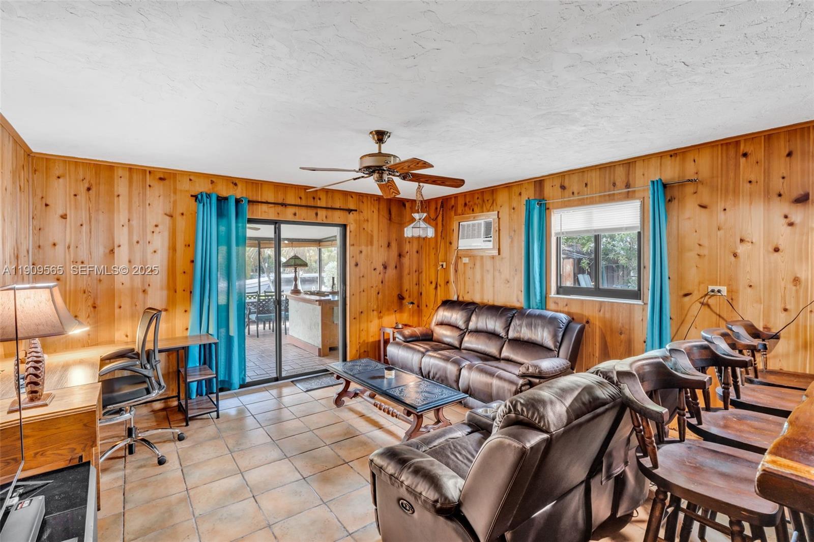 877 Ellen Drive Key Largo, FL 33037 - Photo 24 of 39 a living room with furniture a ceiling fan and a large window