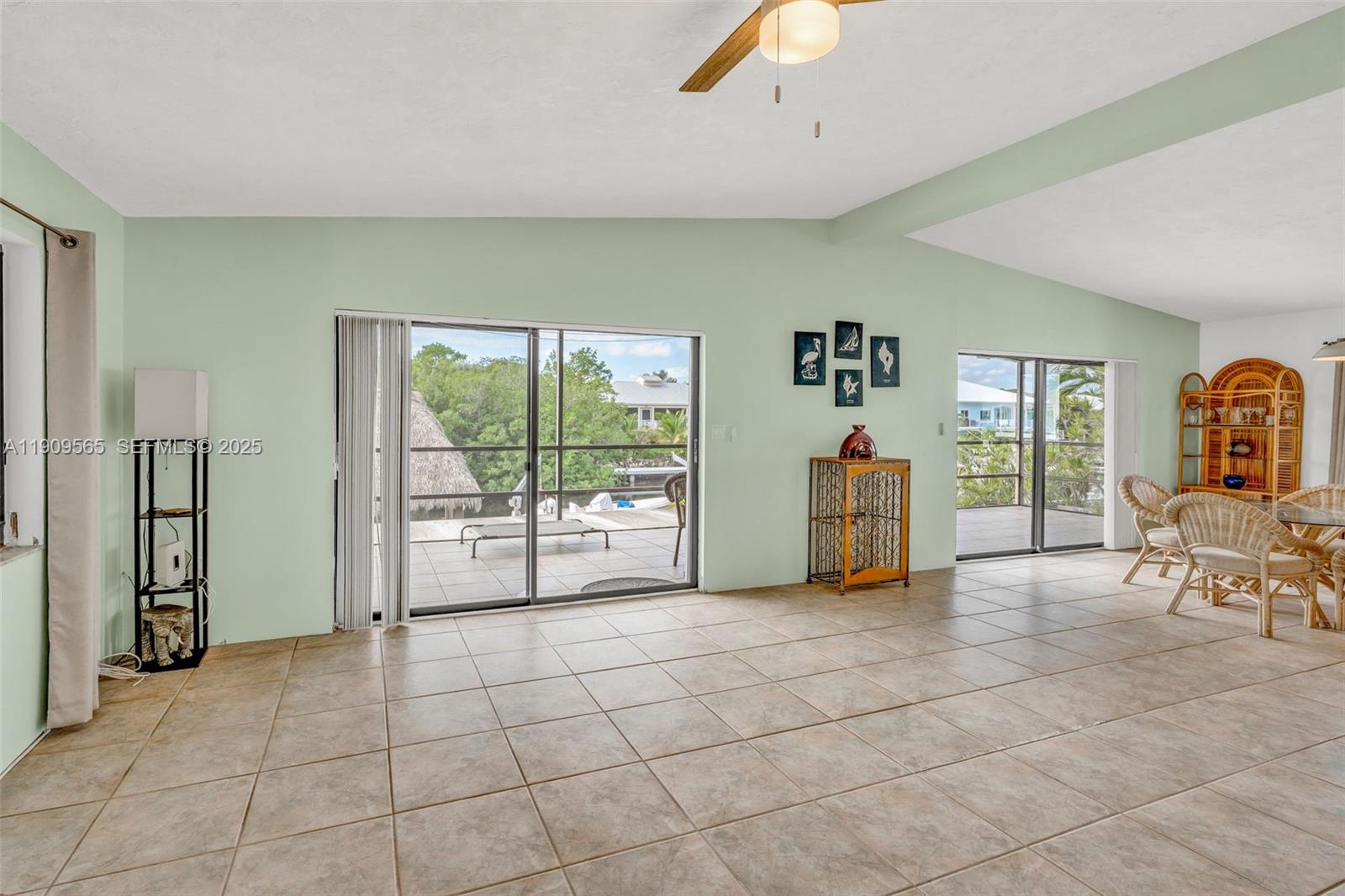 877 Ellen Drive Key Largo, FL 33037 - Photo 3 of 39 a living room with furniture a flat screen tv and a large window
